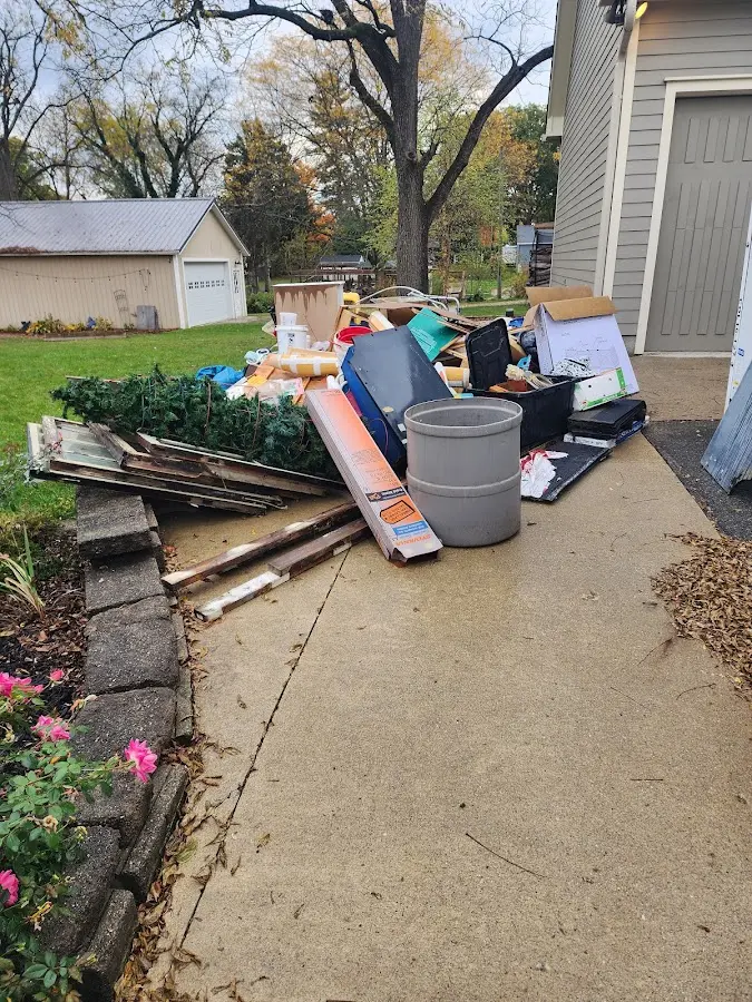 Dumpster being loaded with debris for Estate Cleanout Dumpster Rental in Barberton